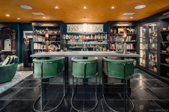 a kitchen with stainless steel appliances granite countertop a table chairs and a large window