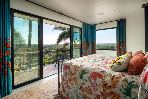 a bedroom with a bed and a large window