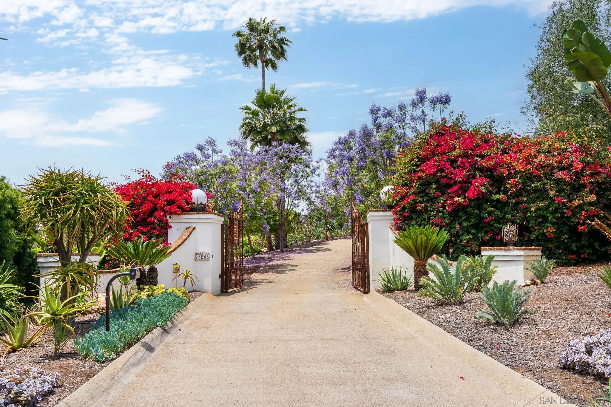 18245 Paseo Victoria Rancho Santa Fe, CA 92067 - Photo 50 of 50 a front view of a house with a yard and a garage