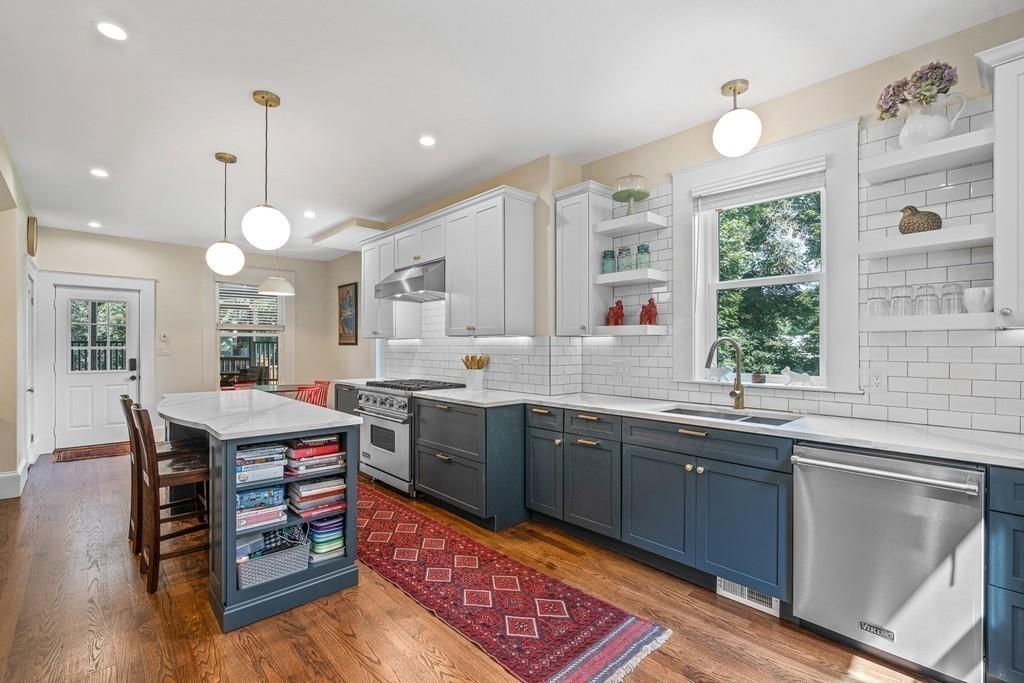 125 Walnut Street Dedham, MA 02026 - Photo 17 of 37 a kitchen with stainless steel appliances granite countertop a stove a sink dishwasher and a refrigerator with wooden floor