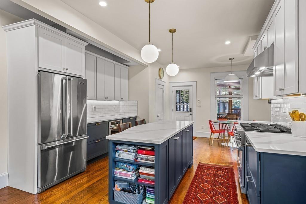 125 Walnut Street Dedham, MA 02026 - Photo 18 of 37 a kitchen with stainless steel appliances granite countertop a refrigerator a stove and a sink with cabinets