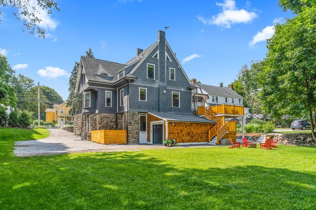 125 Walnut Street Dedham, MA 02026 - Photo 2 of 37 a front view of a house with a yard and garage