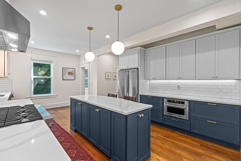 125 Walnut Street Dedham, MA 02026 - Photo 22 of 37 a kitchen with kitchen island a sink stainless steel appliances and cabinets
