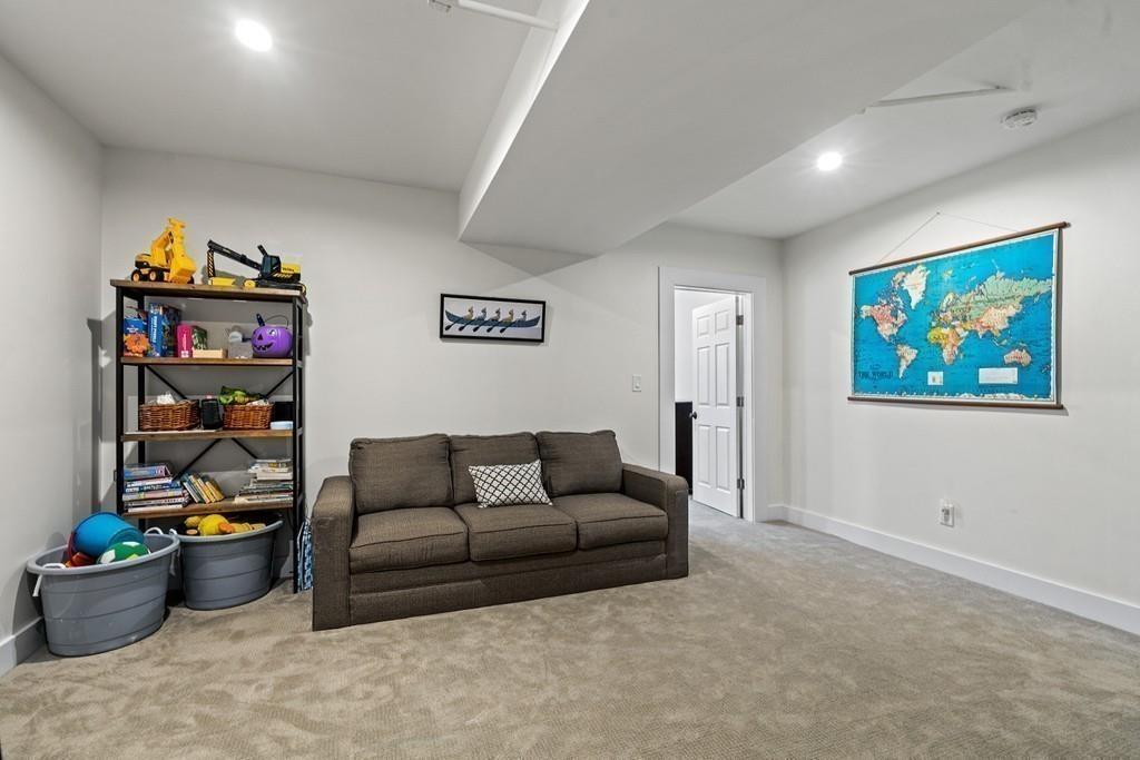 125 Walnut Street Dedham, MA 02026 - Photo 26 of 37 a living room with furniture and a book shelf