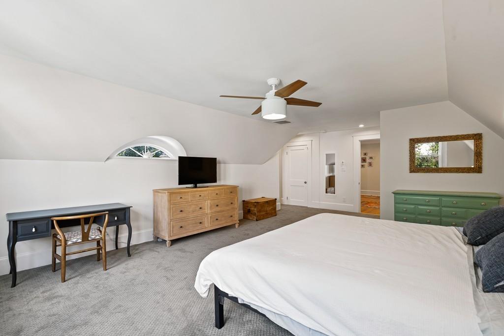 125 Walnut Street Dedham, MA 02026 - Photo 3 of 37 a bedroom with a bed and a chandelier