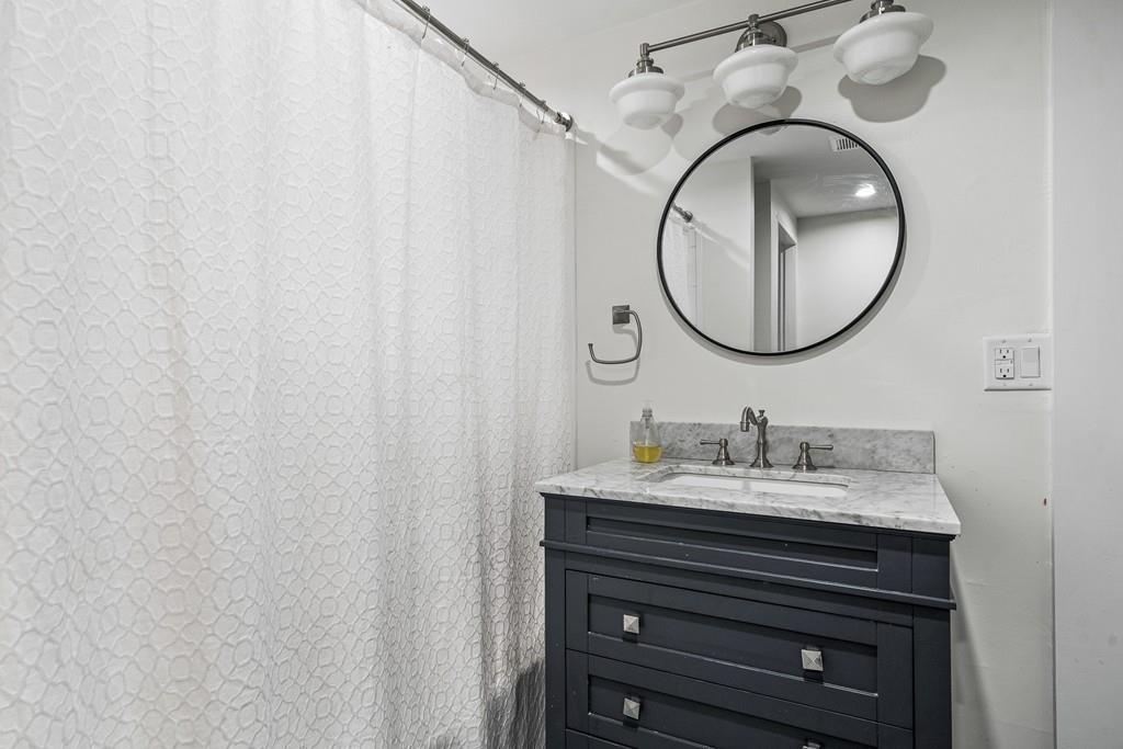 125 Walnut Street Dedham, MA 02026 - Photo 31 of 37 a bathroom with a sink and a mirror