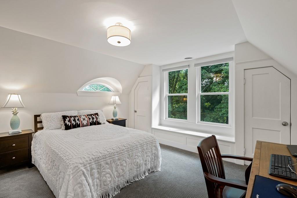 125 Walnut Street Dedham, MA 02026 - Photo 8 of 37 a bedroom with a bed and a chair