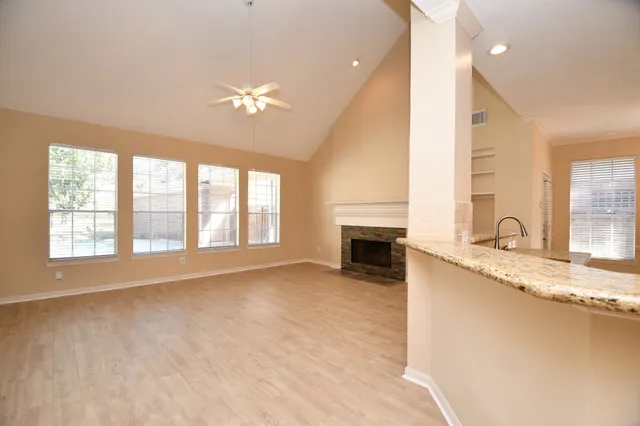 a kitchen with granite countertop kitchen island white cabinets and white appliances
