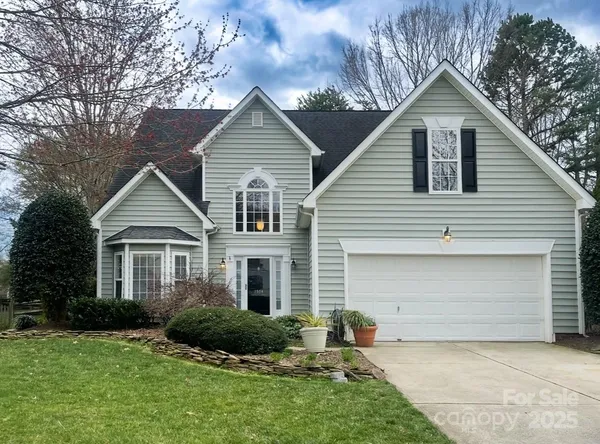 a view of a yard in front view of a house