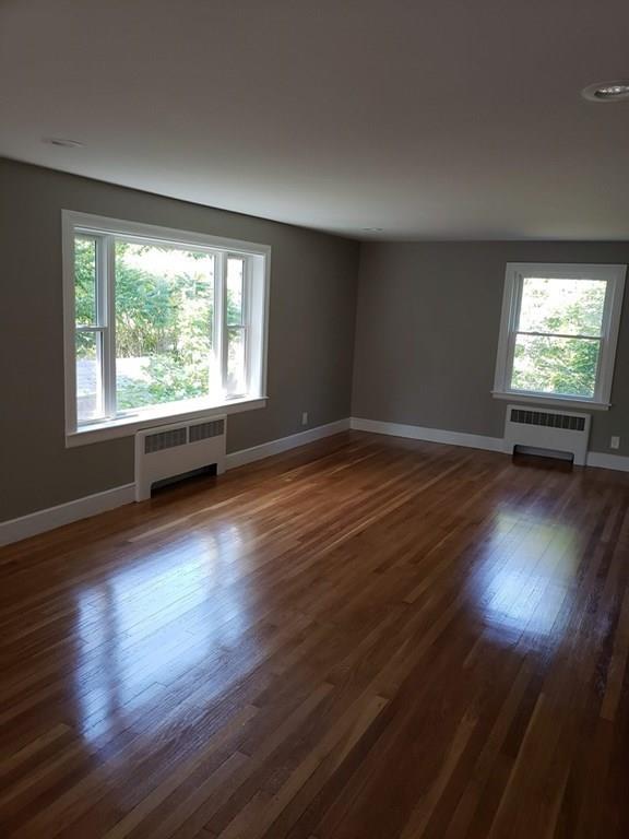 198 Lebanon Hill Road Southbridge, MA 01550 - Photo 11 of 37 an empty room with wooden floor and windows