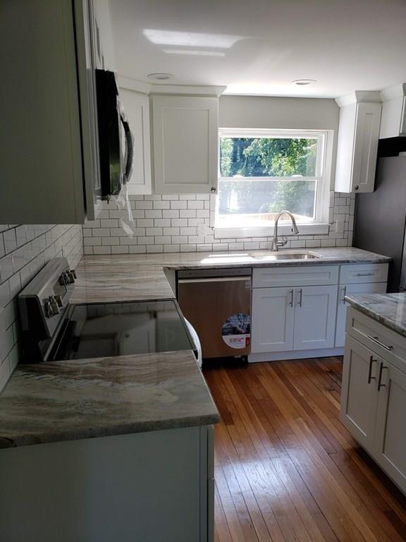 198 Lebanon Hill Road Southbridge, MA 01550 - Photo 16 of 37 a kitchen with kitchen island granite countertop a sink a counter space appliances and cabinets