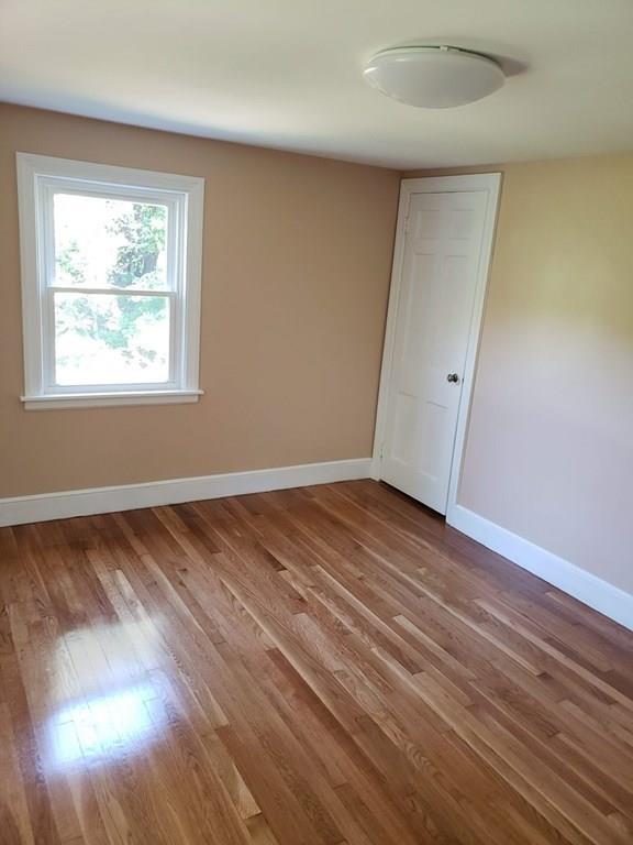 198 Lebanon Hill Road Southbridge, MA 01550 - Photo 28 of 37 an empty room with wooden floor and windows