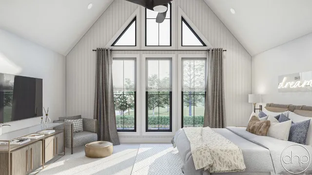 a bedroom with a large bed and a flat screen tv