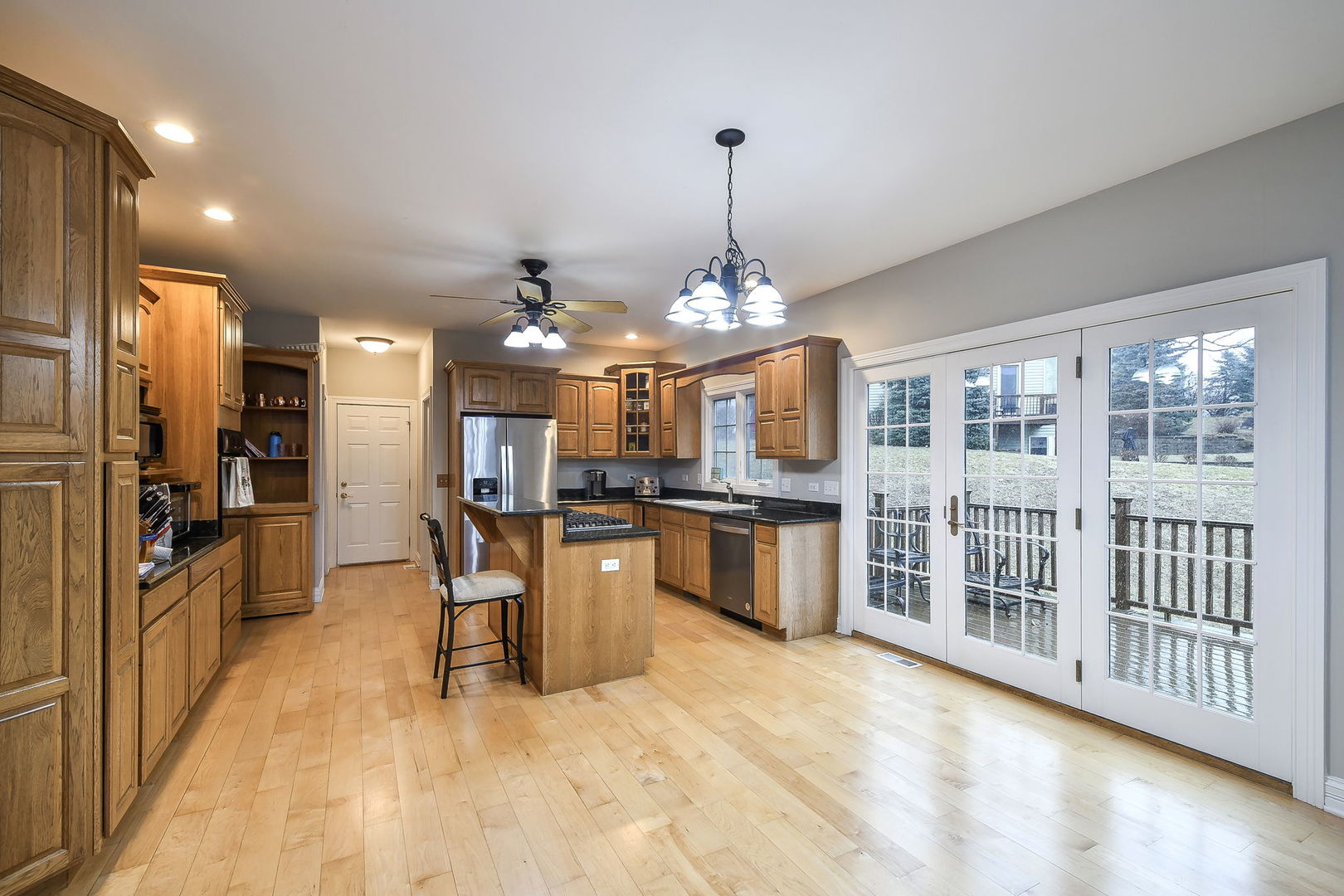 104 Bruell Street Yorkville, IL 60560 - Photo 11 of 35 a view of a kitchen with kitchen island a large counter top stainless steel appliances and cabinets