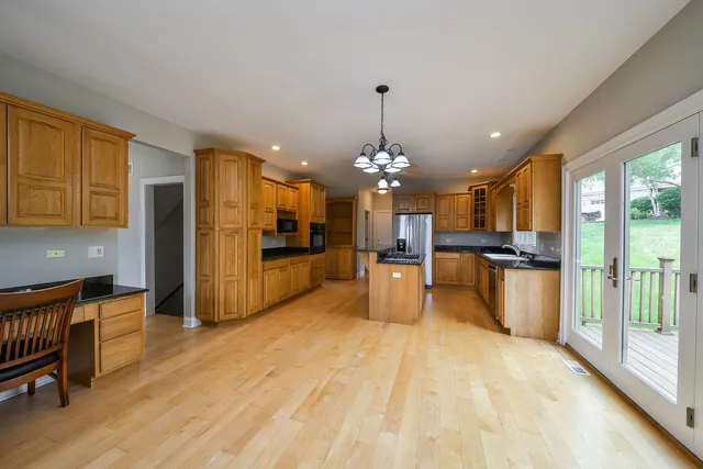 a view of a kitchen with refrigerator and cabinets