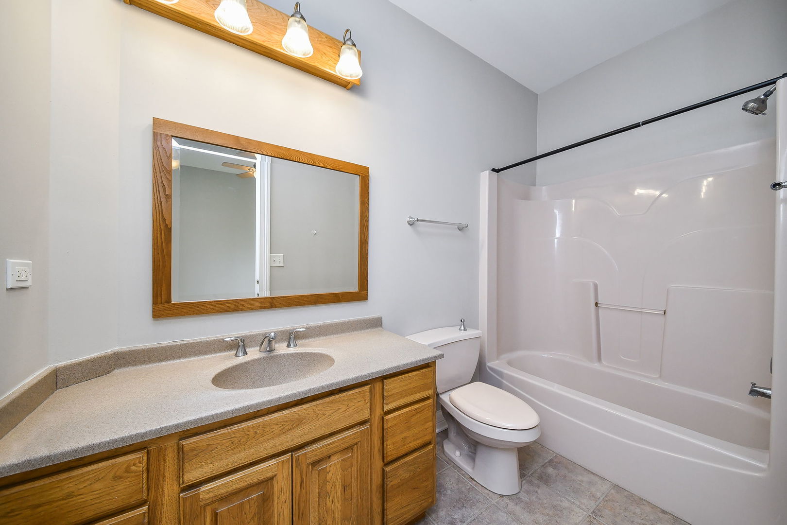 104 Bruell Street Yorkville, IL 60560 - Photo 24 of 35 a bathroom with a granite countertop sink toilet and shower
