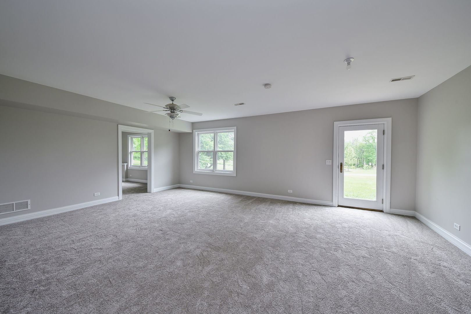 104 Bruell Street Yorkville, IL 60560 - Photo 31 of 35 a view of a big room with windows and chandelier fan