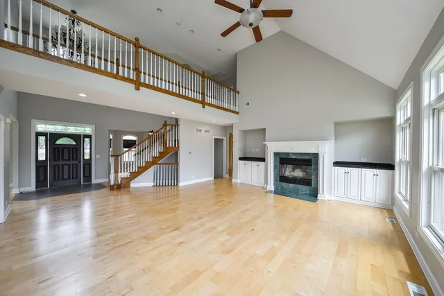 a view of an empty room with a fireplace and a window