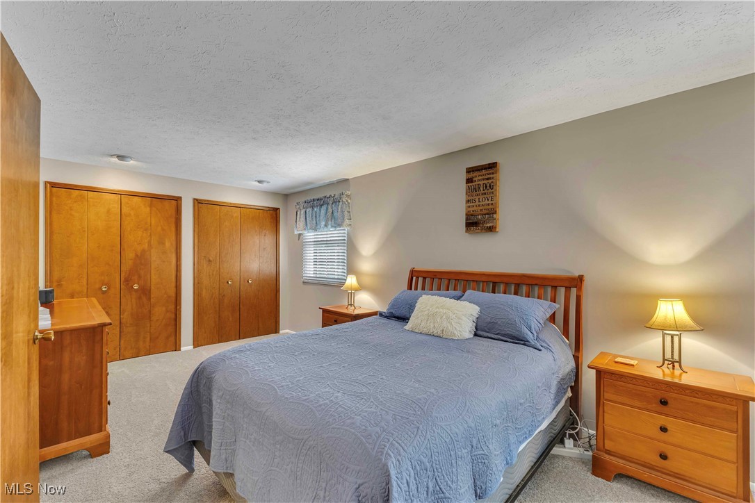4090 Ridgeview Road Cleveland, OH 44144 - Photo 20 of 40 Carpeted bedroom with two closets and a textured ceiling