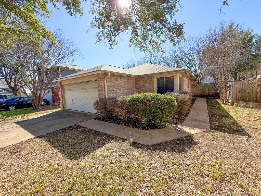 11101 Franklins Tale Loop Austin, TX 78748 - Photo 1 of 39 View of property exterior featuring brick siding, concrete driveway, a garage, and roof with shingles