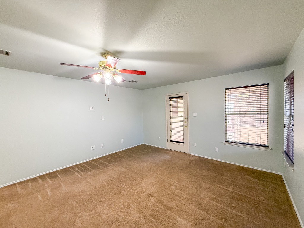11101 Franklins Tale Loop Austin, TX 78748 - Photo 13 of 38 Unfurnished room featuring carpet flooring and a ceiling fan