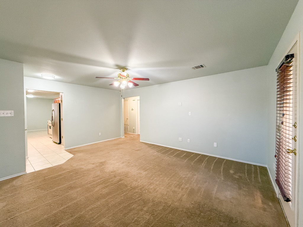 11101 Franklins Tale Loop Austin, TX 78748 - Photo 14 of 38 Carpeted empty room with baseboards and ceiling fan