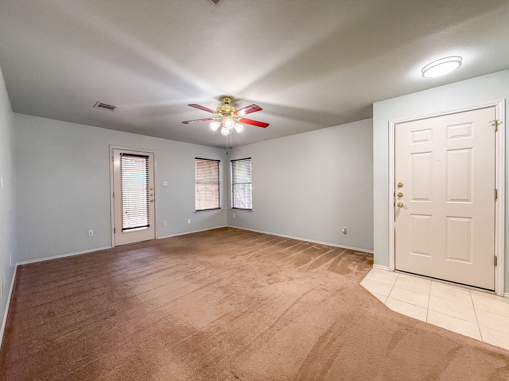 11101 Franklins Tale Loop Austin, TX 78748 - Photo 17 of 39 Foyer featuring light carpet, a ceiling fan, a textured ceiling, and light tile patterned floors
