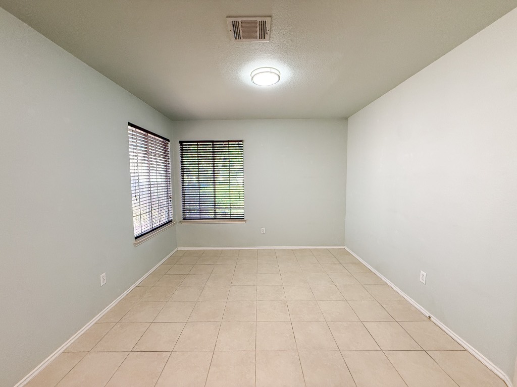 11101 Franklins Tale Loop Austin, TX 78748 - Photo 20 of 38 Unfurnished room with a textured ceiling and light tile patterned floors