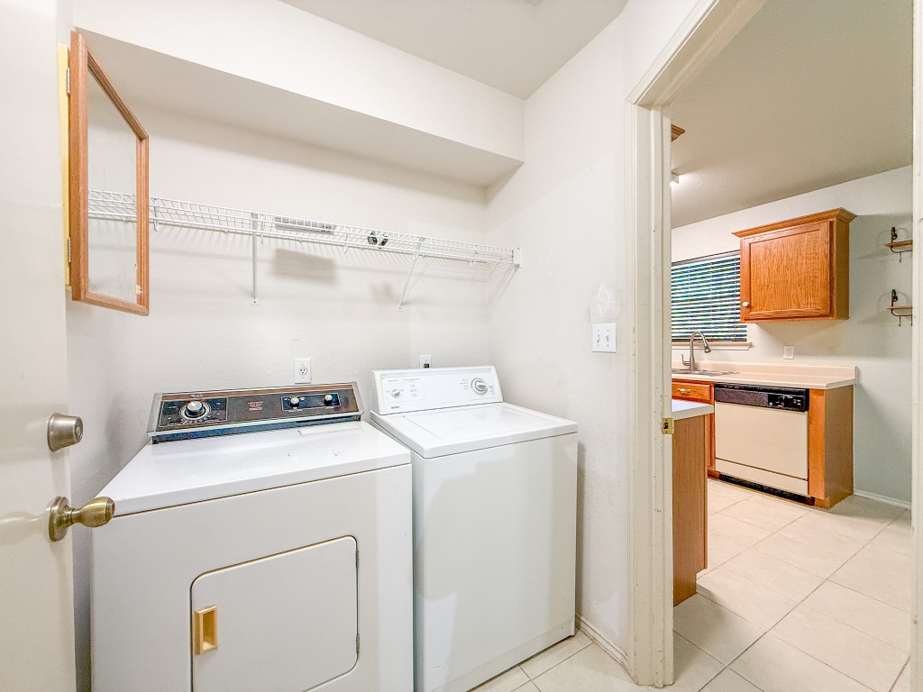 11101 Franklins Tale Loop Austin, TX 78748 - Photo 23 of 38 Laundry room featuring washer and dryer and light tile patterned floors