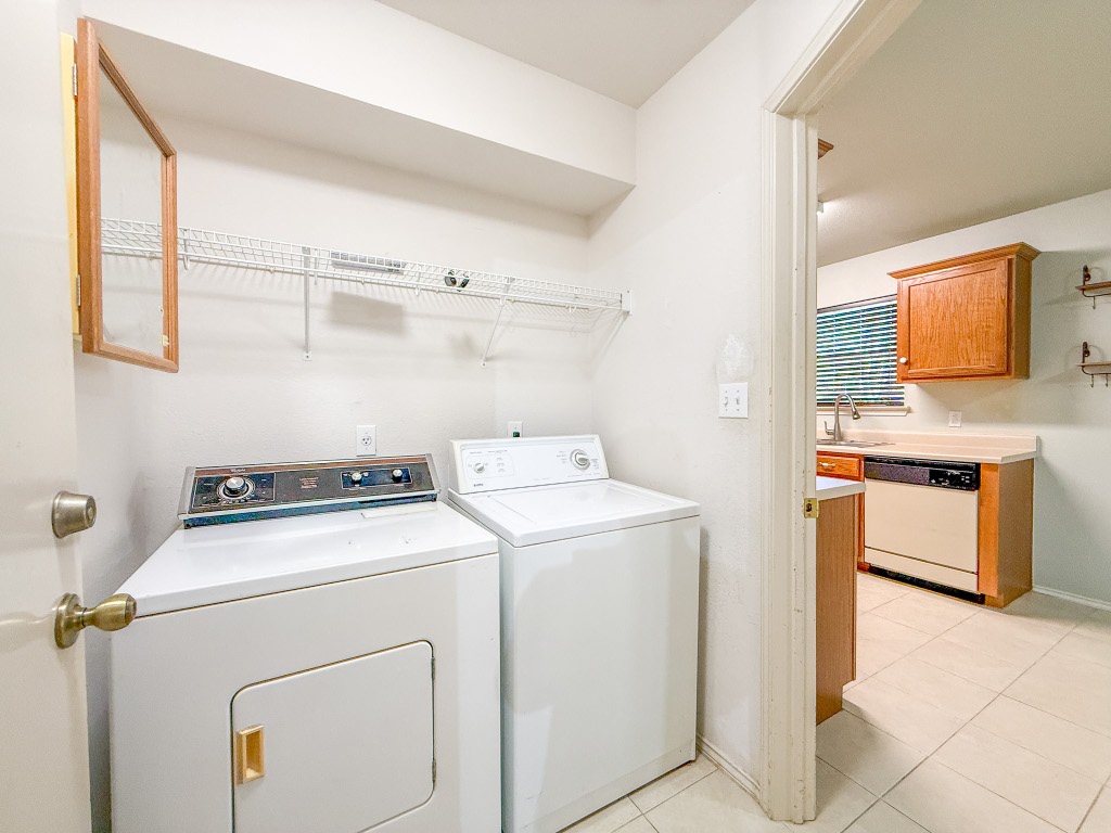 11101 Franklins Tale Loop Austin, TX 78748 - Photo 24 of 39 Laundry area with washing machine and dryer and light tile patterned floors