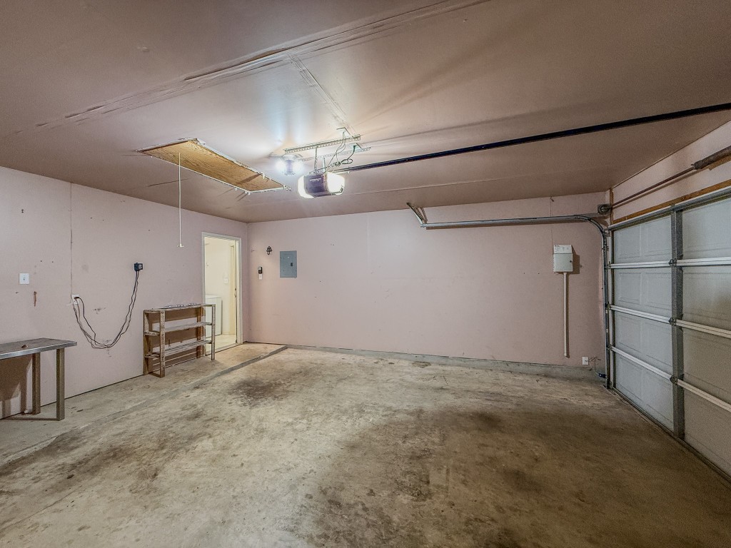 11101 Franklins Tale Loop Austin, TX 78748 - Photo 25 of 39 Garage featuring electric panel and a garage door opener