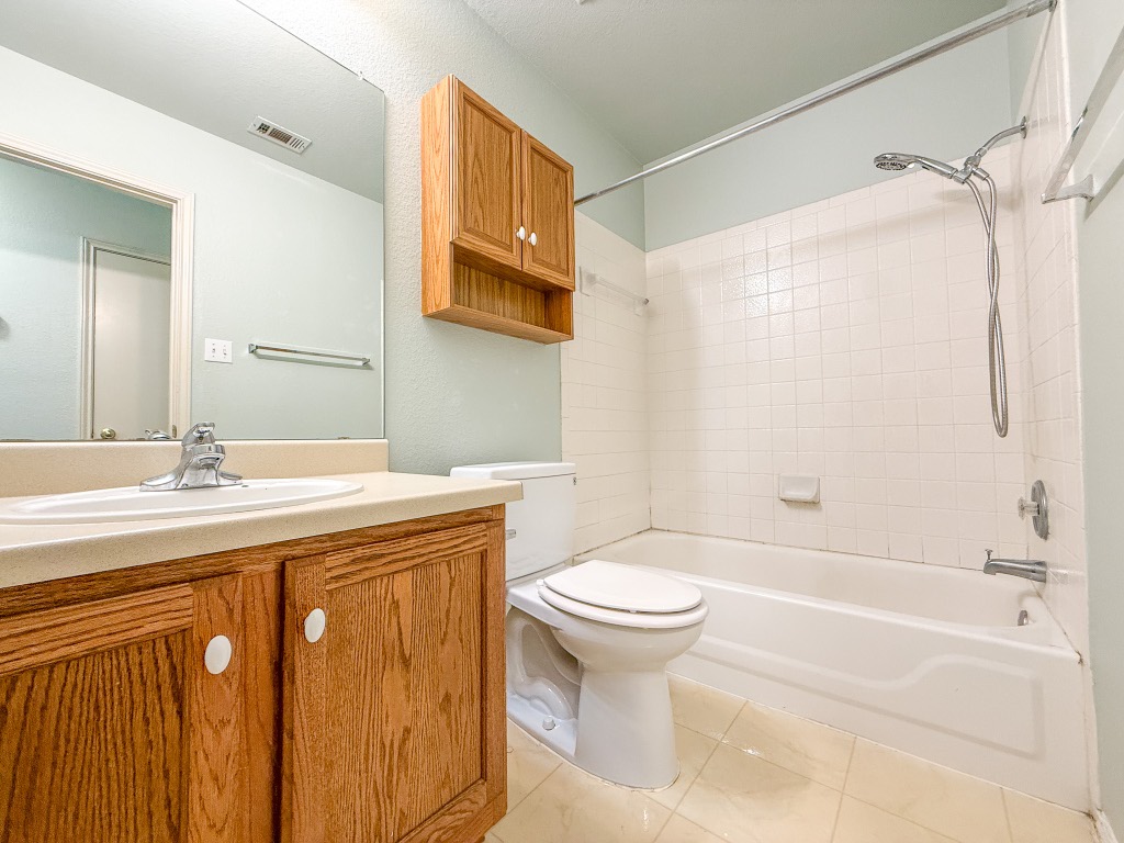 11101 Franklins Tale Loop Austin, TX 78748 - Photo 27 of 38 Bathroom with bathing tub / shower combination, vanity, and light tile patterned flooring