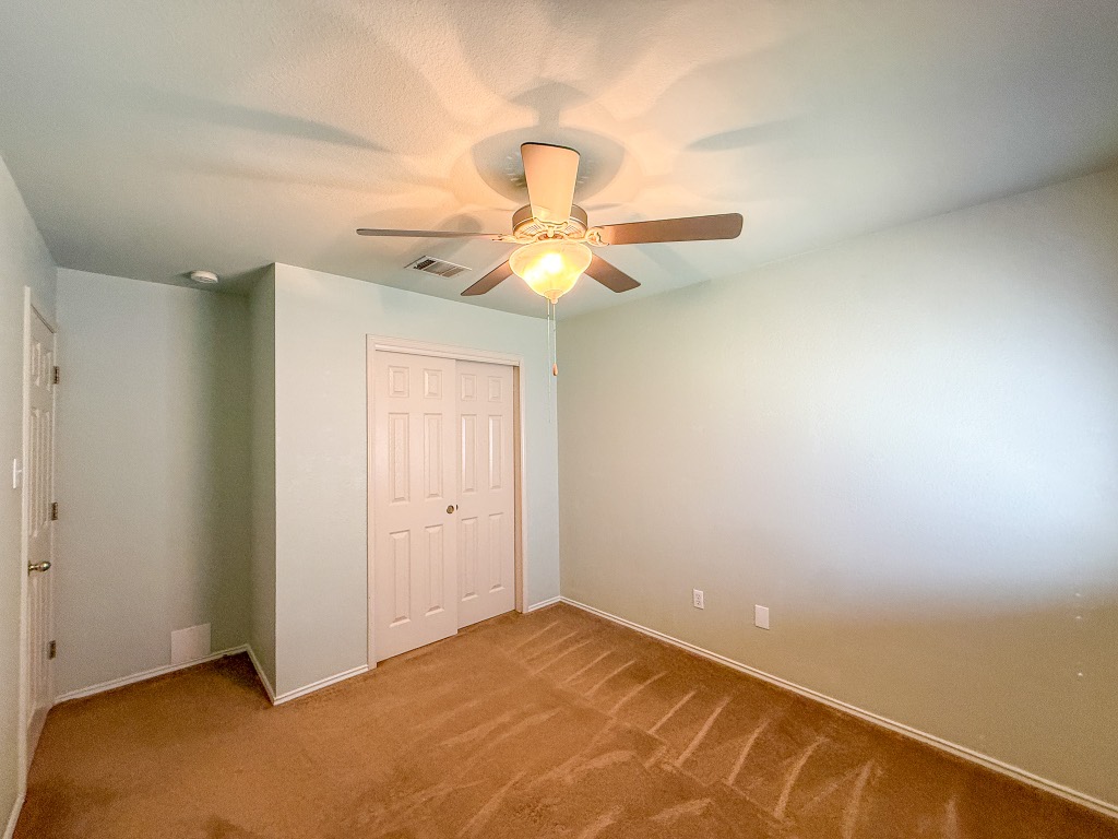 11101 Franklins Tale Loop Austin, TX 78748 - Photo 28 of 39 Unfurnished bedroom with a closet, light colored carpet, and a ceiling fan