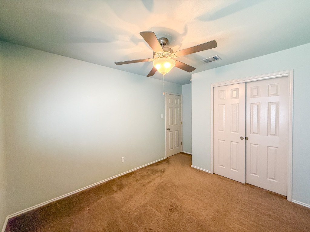 11101 Franklins Tale Loop Austin, TX 78748 - Photo 29 of 38 Unfurnished bedroom with a closet, a ceiling fan, and carpet floors