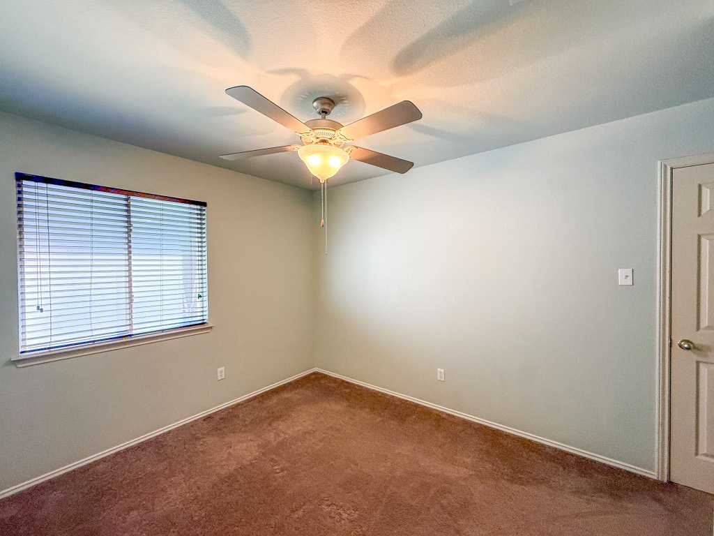 11101 Franklins Tale Loop Austin, TX 78748 - Photo 30 of 39 Carpeted empty room with baseboards and ceiling fan