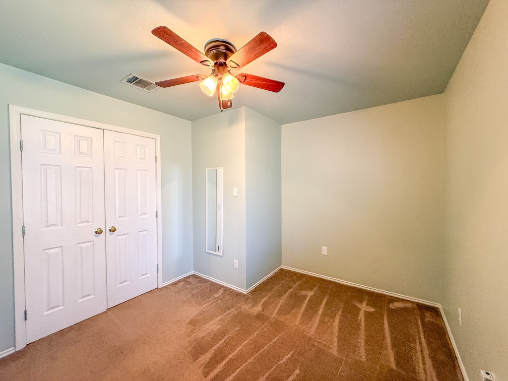 11101 Franklins Tale Loop Austin, TX 78748 - Photo 33 of 39 Unfurnished bedroom featuring carpet floors, ceiling fan, and a closet