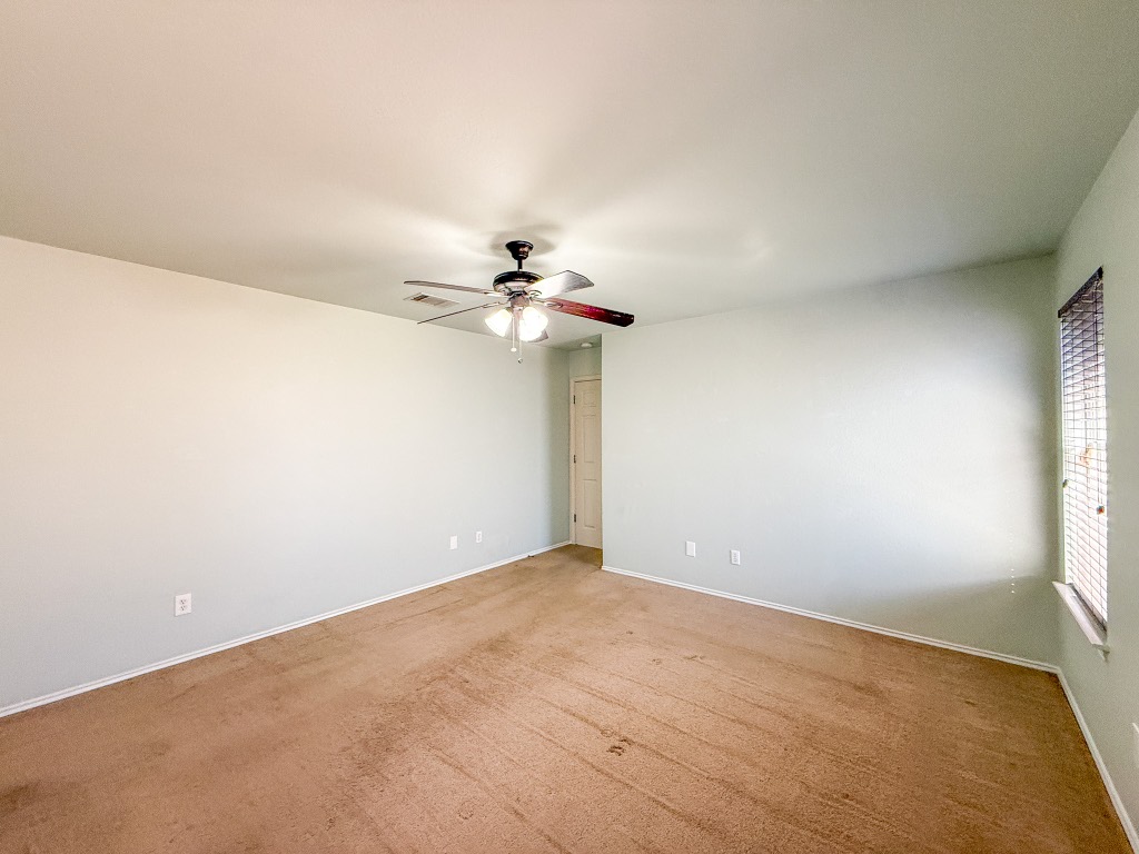 11101 Franklins Tale Loop Austin, TX 78748 - Photo 36 of 39 Carpeted empty room featuring a ceiling fan and baseboards