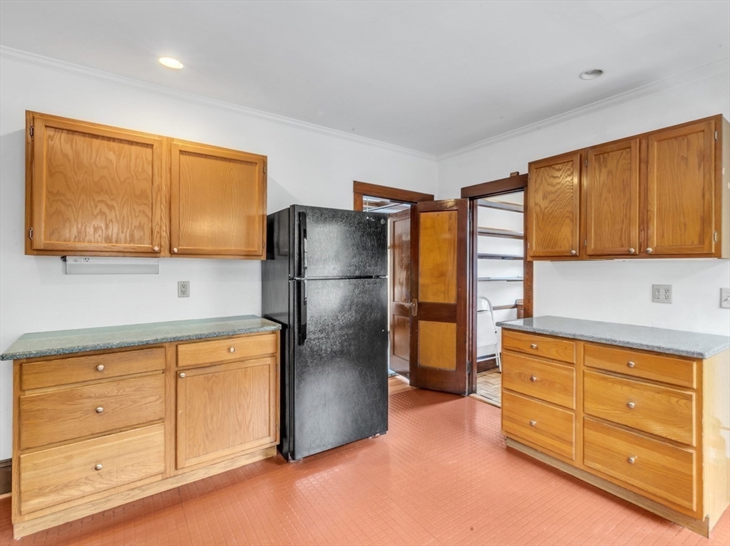 115 Sumner Road Brookline, MA 02445 - Photo 12 of 25 a kitchen with stainless steel appliances granite countertop a refrigerator and cabinets