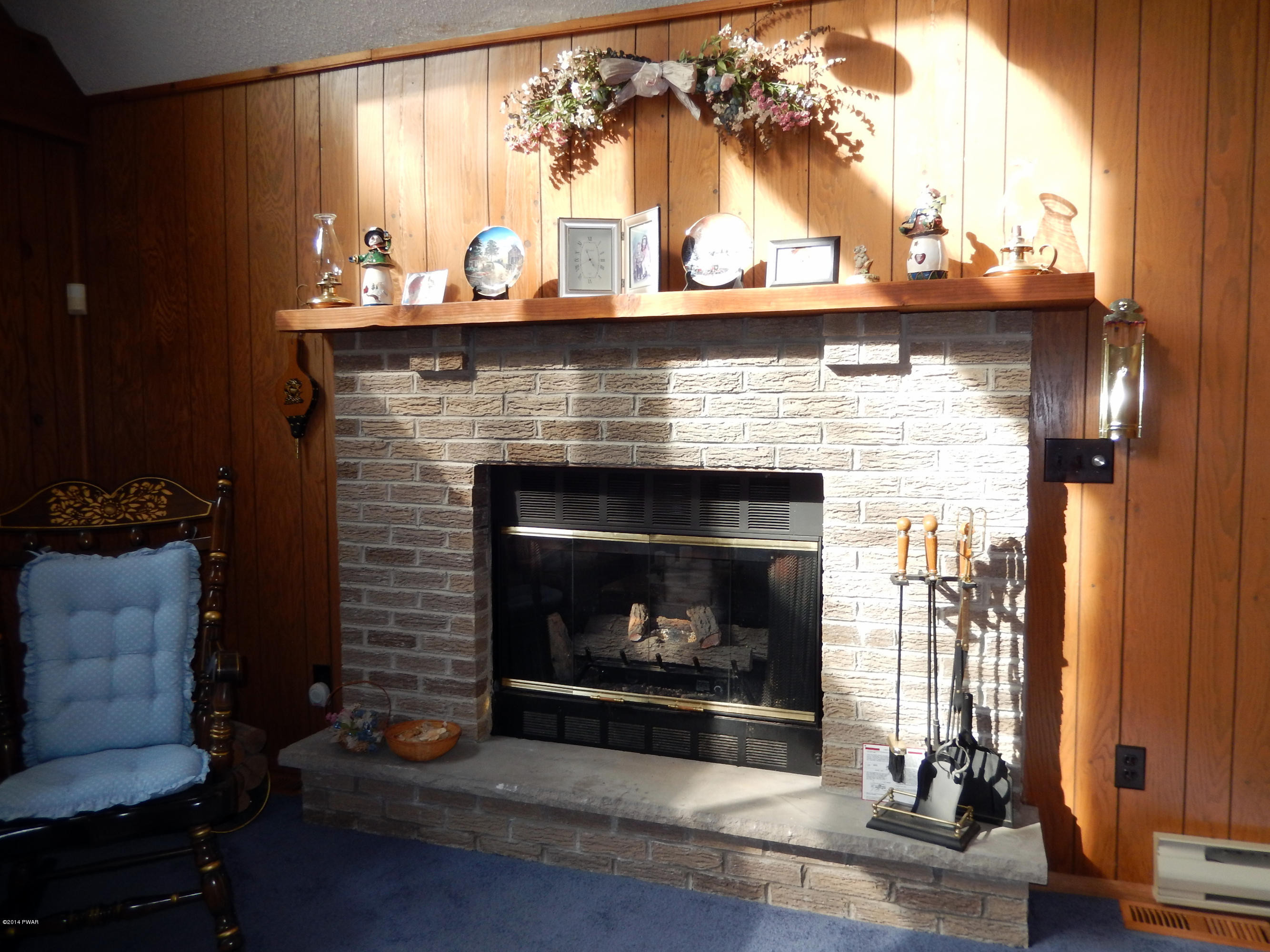 3190 Northgate Road Lake Ariel, PA 18436 - Photo 15 of 56 a living room with a fireplace wooden floor and a large window