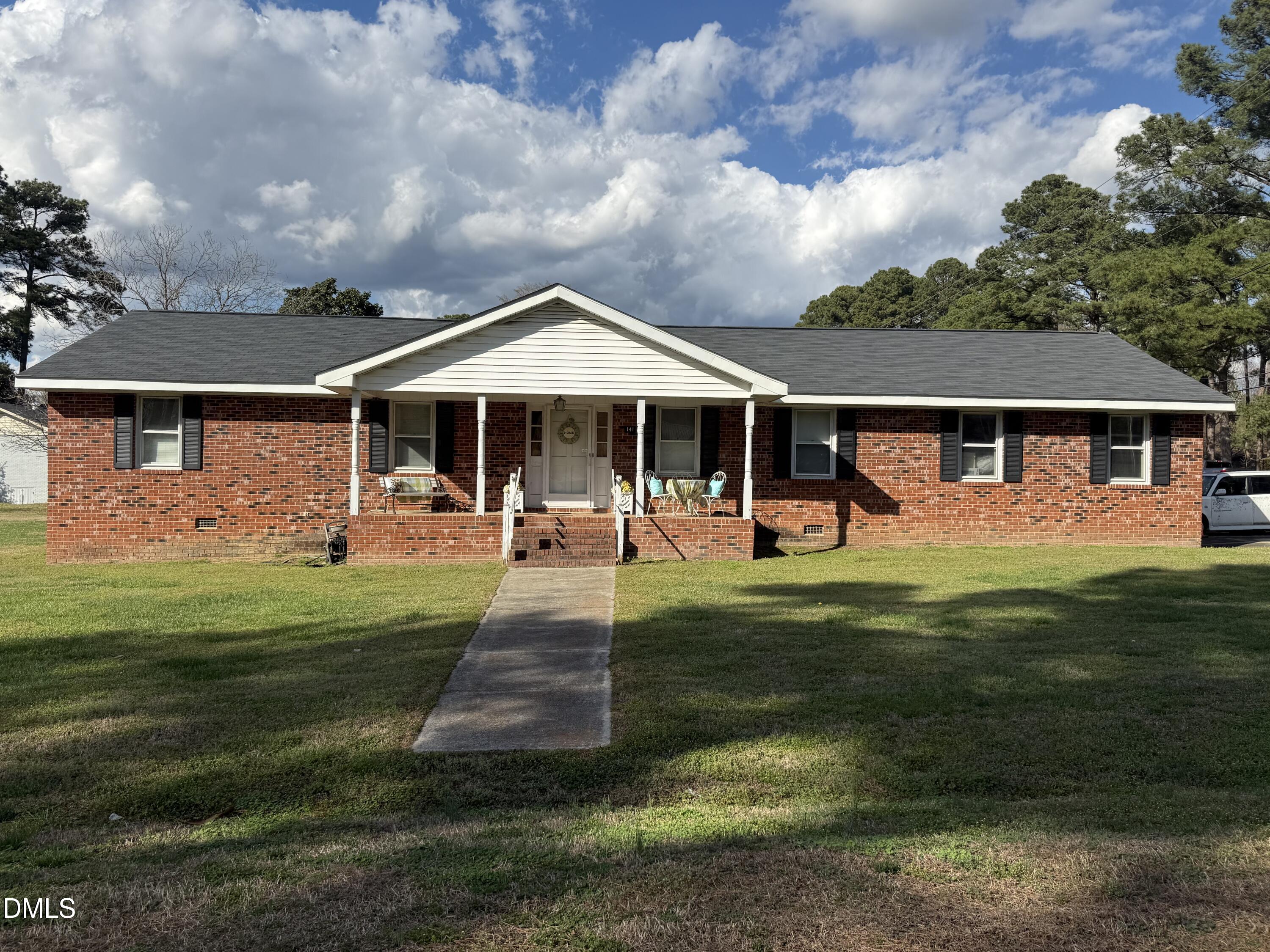 141 Forest Lane Wendell, NC 27591 - Photo 2 of 9 a front view of a house with garden