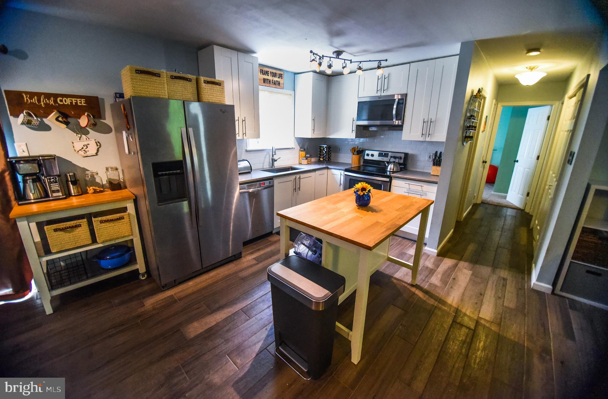 4777 St Leonard Road St. Leonard, MD 20685 - Photo 6 of 31 a kitchen with stainless steel appliances wooden floor and a refrigerator
