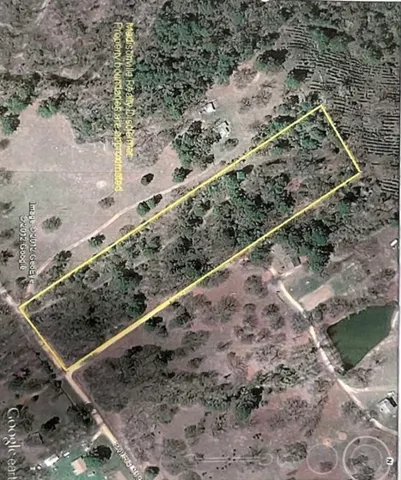 a view of a yard with wooden fence