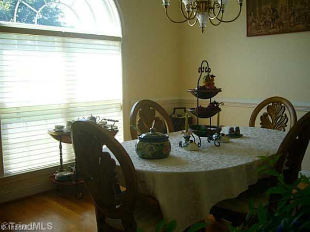 5400 Gray Leigh Drive Oak Ridge, NC 27310 - Photo 7 of 16 Dining Room. The dining room features a large palladium window and special window treatment, volume ceiling, hardwood floor with the cherry accent, wonderful moldings and wall space which makes it easy to place furniture.