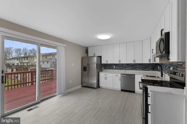 a kitchen with refrigerator and cabinets