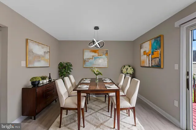 a dining room with furniture and wooden floor
