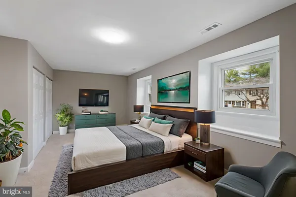 a bedroom with a balcony a bed and a flat screen tv