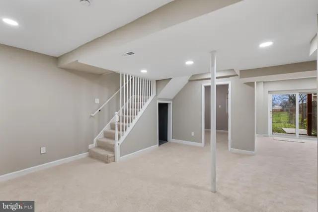 a view of an empty room with stairs