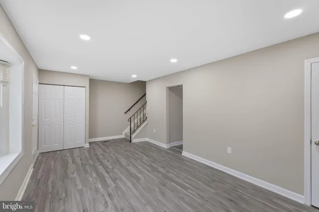 a view of an empty room with wooden floor