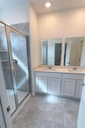 a bathroom with a double vanity sink and mirror