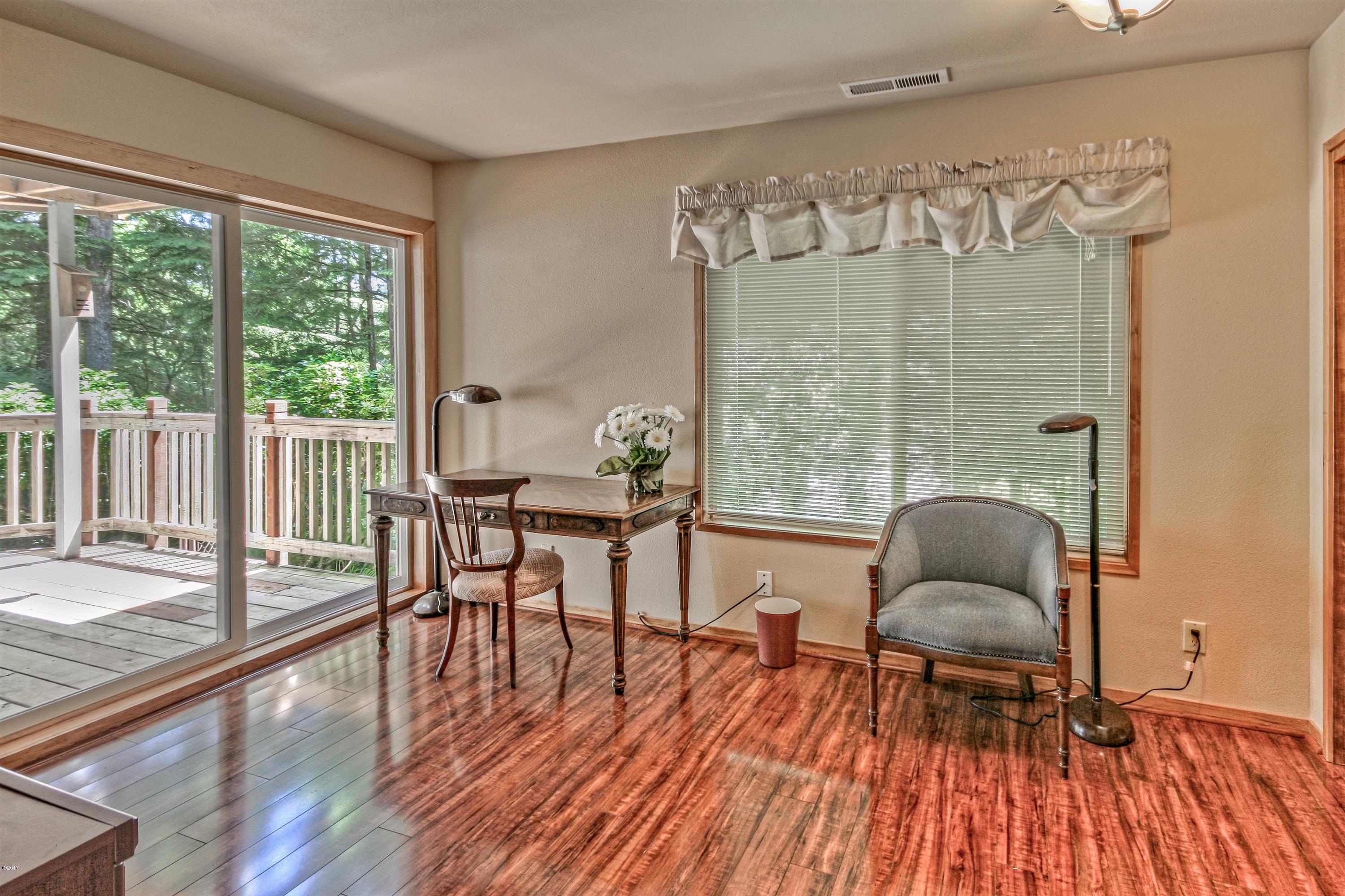 17 Big Tree Road Gleneden Beach, OR 97388 - Photo 29 of 52 a workspace with wooden floor and large windows